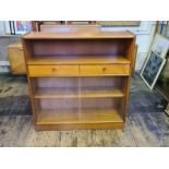 A mid century Nathan teak bookcase with 2 drawers, glass sliders and open shelf. 102cm wide x 30cm