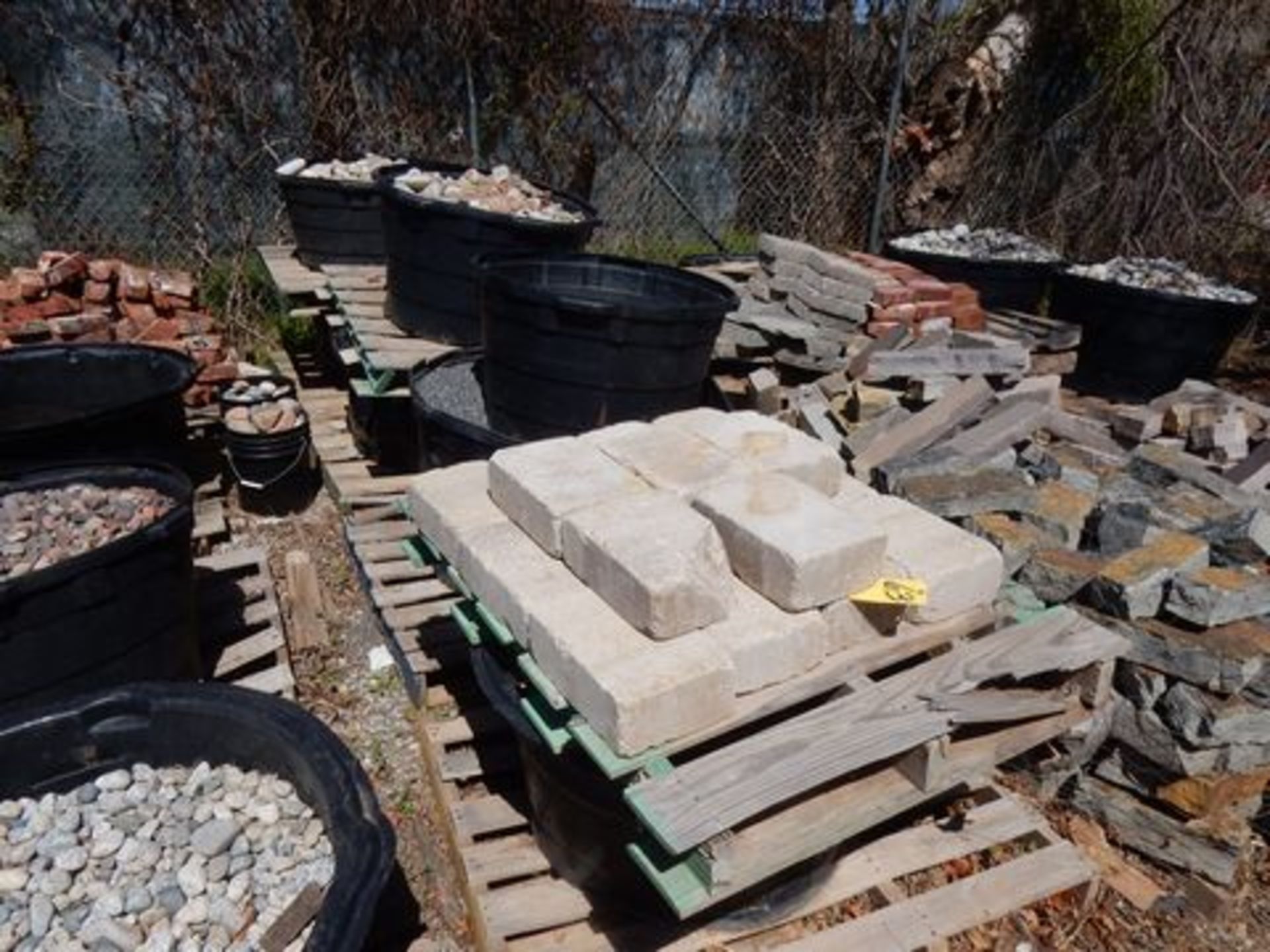 LOT (1) PALLET W/CONCRETE BRICKS & (7) TUBS W/RIVER ROCKS