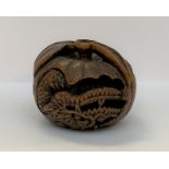 NETSUKE en buis figurant un dragon enroulé sur lui-même dans un mikan, son oeil visible incrusté