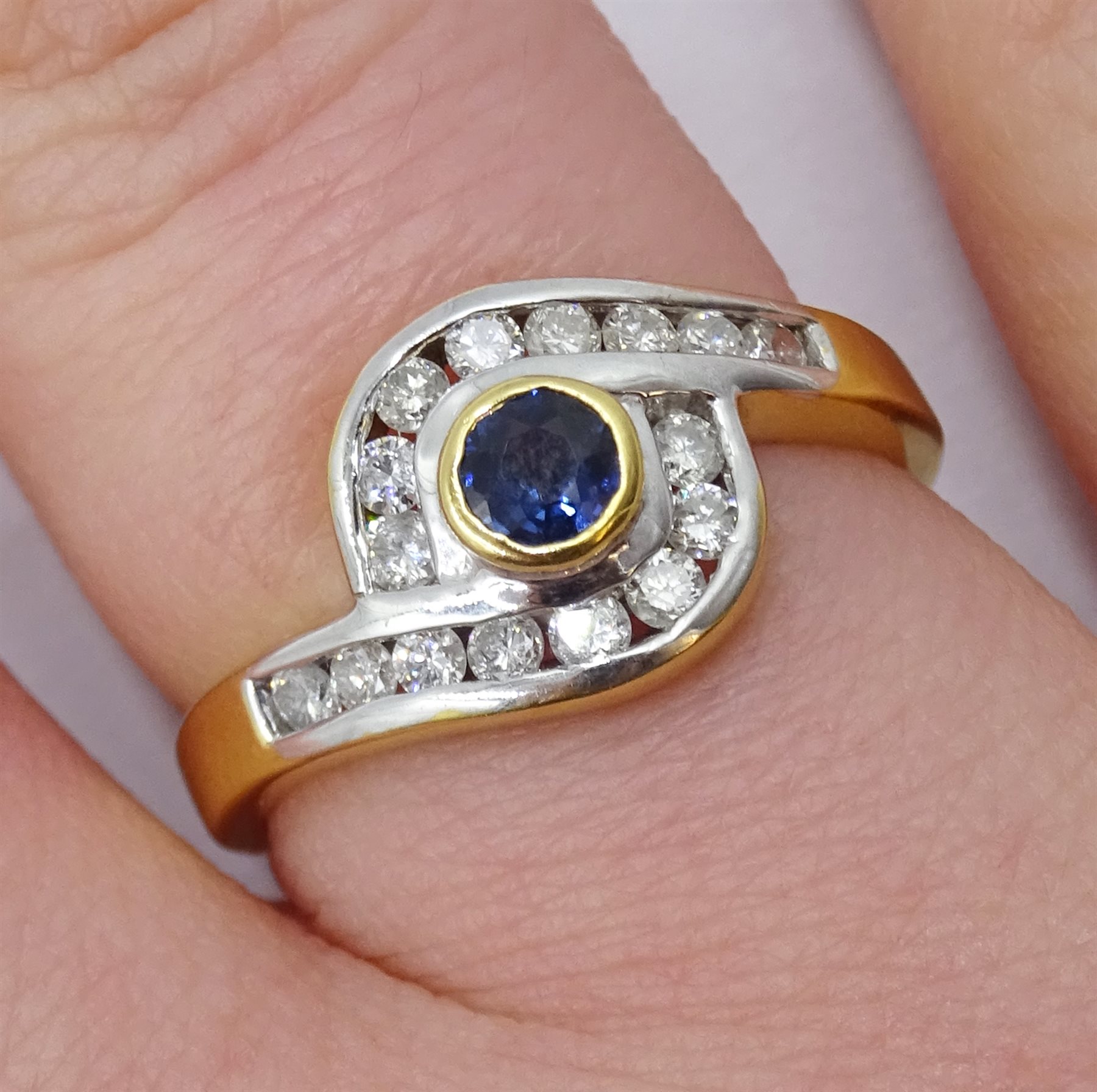 18ct gold diamond and sapphire crossover ring, the bezel set sapphire with 16 channel set diamond su - Image 2 of 4