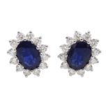 Pair of white gold sapphire and diamond cluster stud earrings, stamped 18K, total sapphire weight ap