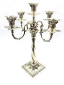 Edwardian silver five light candelabrum of Adam design with scroll branches, the square base cast wi