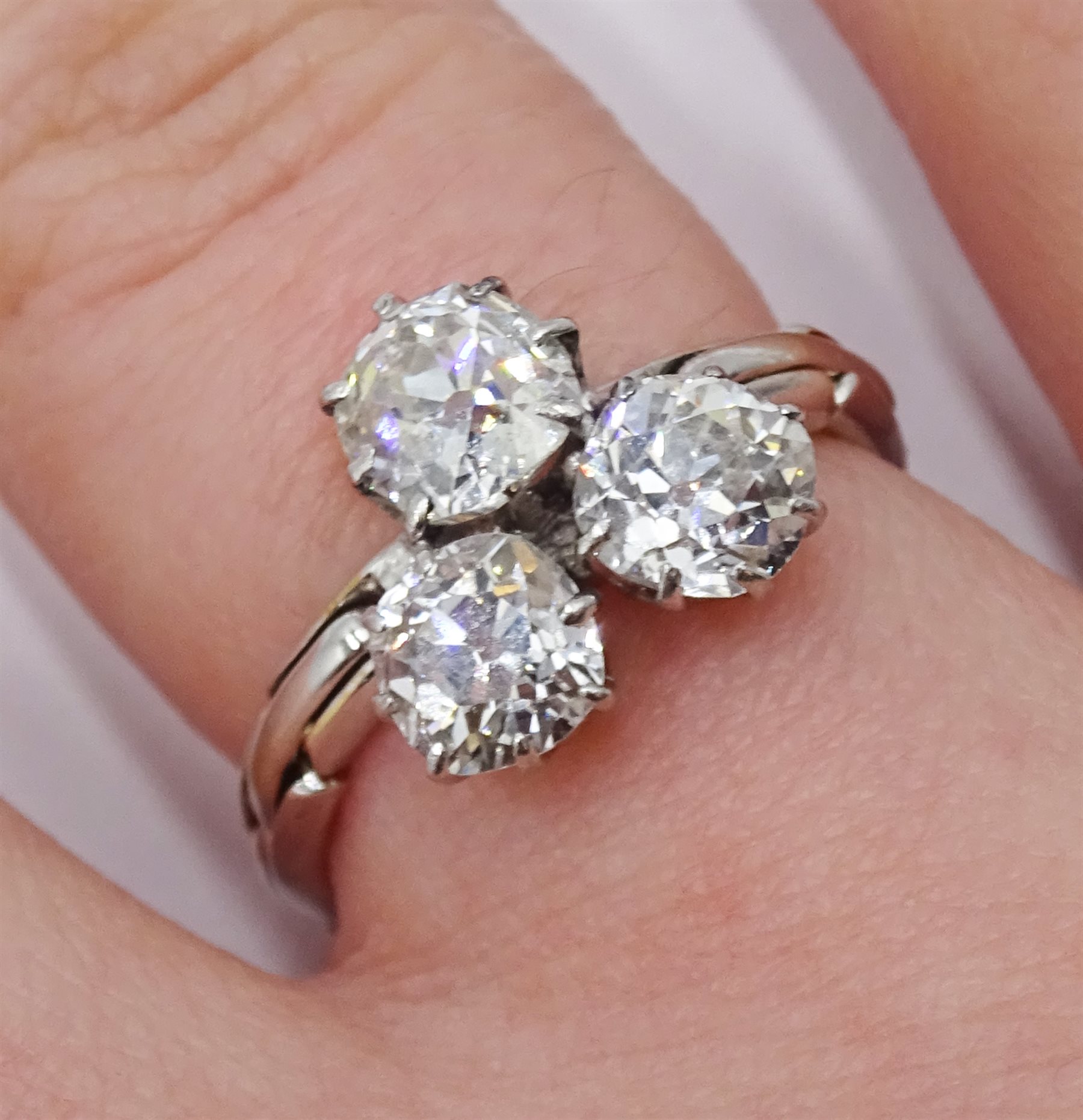 Early 20th century platinum three stone old cut diamond ring, on later 17ct white gold expanding sha - Image 2 of 4