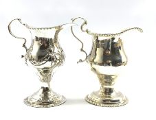 George III silver baluster cream jug embossed with trailing garlands on a pedestal foot London 1782