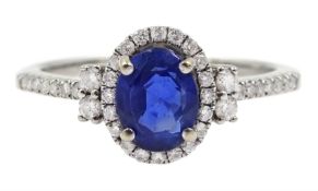 18ct white gold oval sapphire and diamond halo ring, with diamond set shoulders, stamped 750