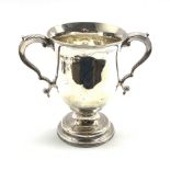 George III silver two handled loving cup of baluster form with leaf capped scroll handles and pedest