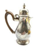 Late Victorian Britannia standard hammered silver baluster hot milk jug with domed cover, stained wo