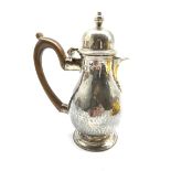 Late Victorian Britannia standard hammered silver baluster hot milk jug with domed cover, stained wo