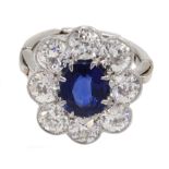 Early 20th century platinum sapphire and diamond cluster ring, the central oval sapphire with eight