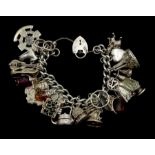Heavy silver curb chain bracelet, with various charms including rabbit in a hut, money box teapot, g
