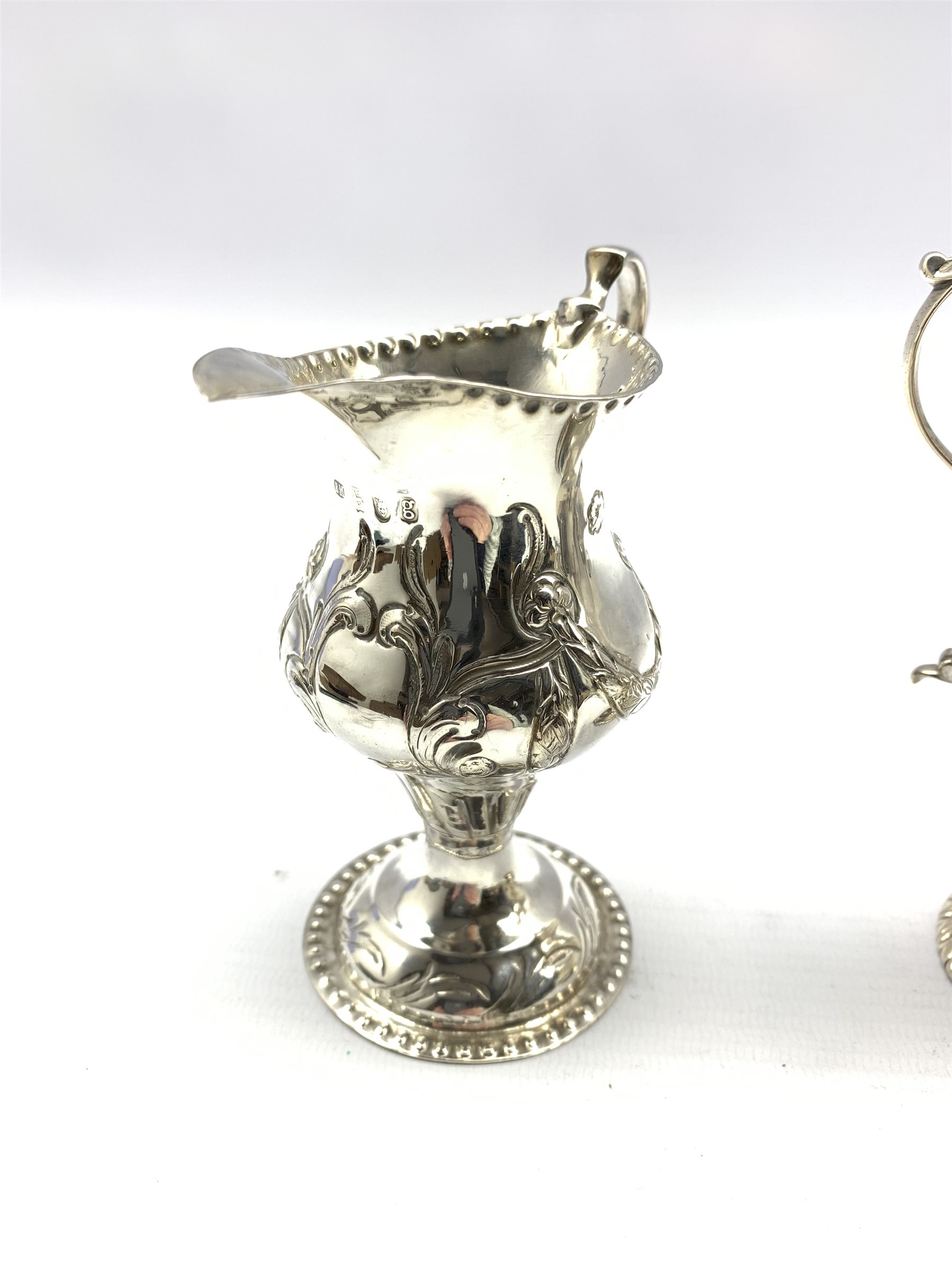 George III silver baluster cream jug embossed with trailing garlands on a pedestal foot London 1782 - Image 2 of 5