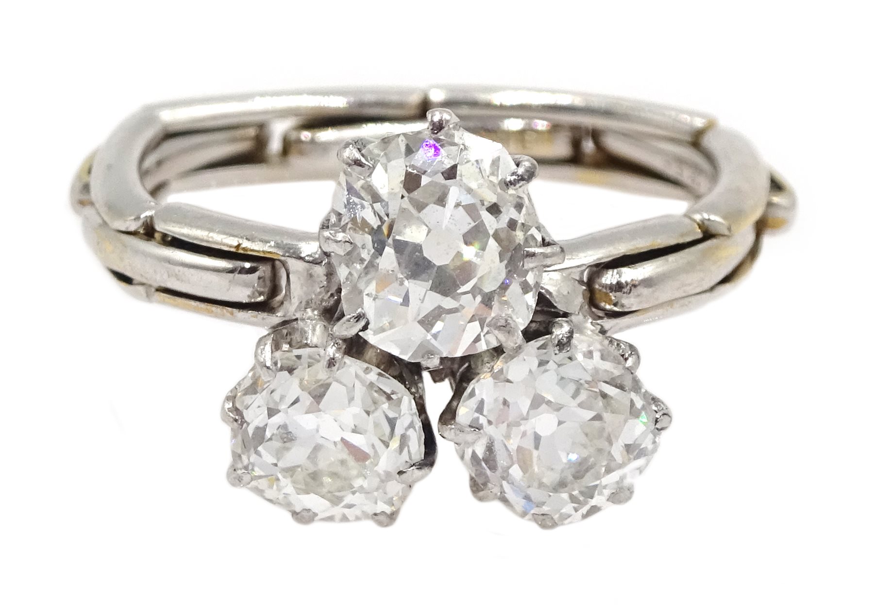 Early 20th century platinum three stone old cut diamond ring, on later 17ct white gold expanding sha