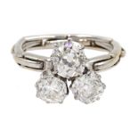 Early 20th century platinum three stone old cut diamond ring, on later 17ct white gold expanding sha