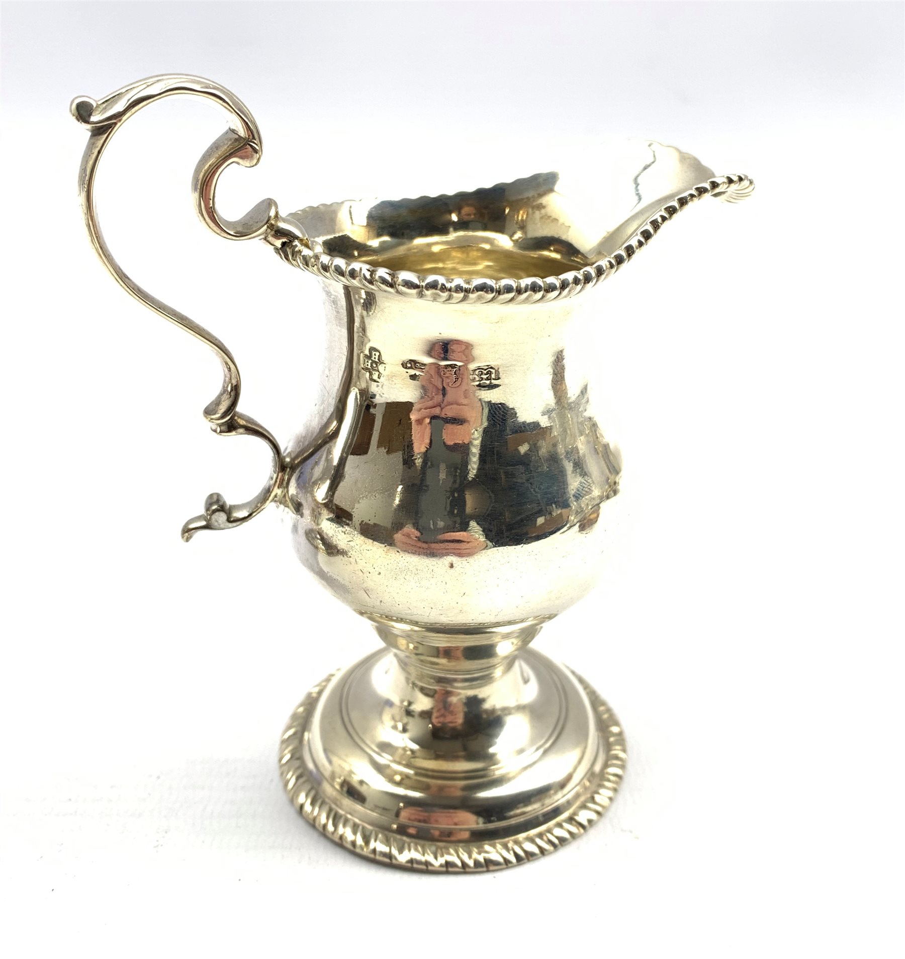 George III silver baluster cream jug embossed with trailing garlands on a pedestal foot London 1782 - Image 4 of 5