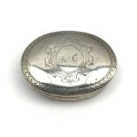 Early 19th century silver oval box with hinged cover, the cartouche inscribed 'A C' with engraved ro