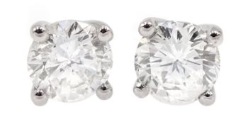 Pair of 18ct white gold diamond stud earrings, stamped 750, total diamond weight 1.05 carat, with Wo