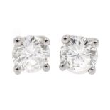 Pair of 18ct white gold diamond stud earrings, stamped 750, total diamond weight 1.05 carat, with Wo