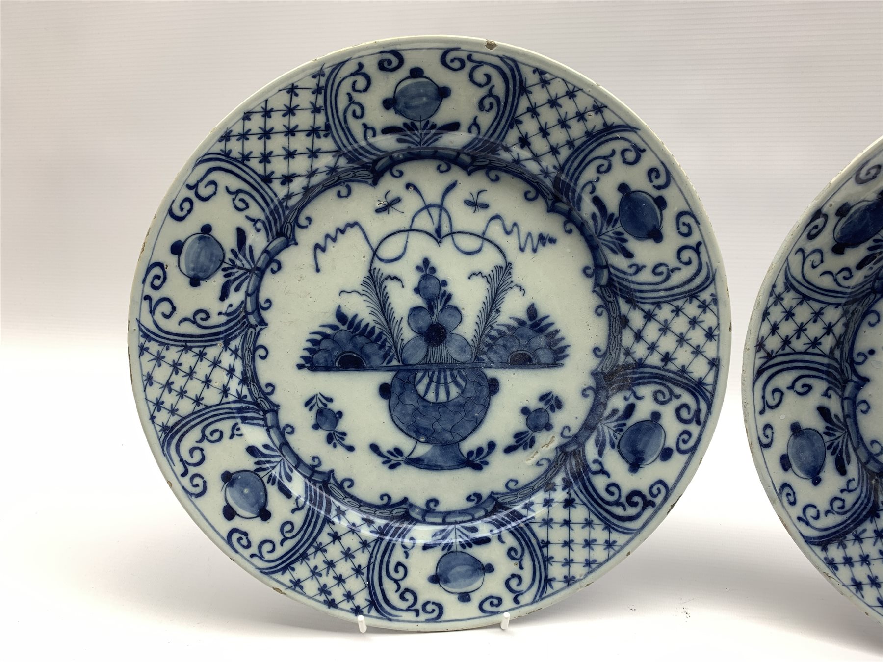 Pair of 18th century Delft blue and white chargers, centrally painted with a vase of flowers, the bo - Image 3 of 4