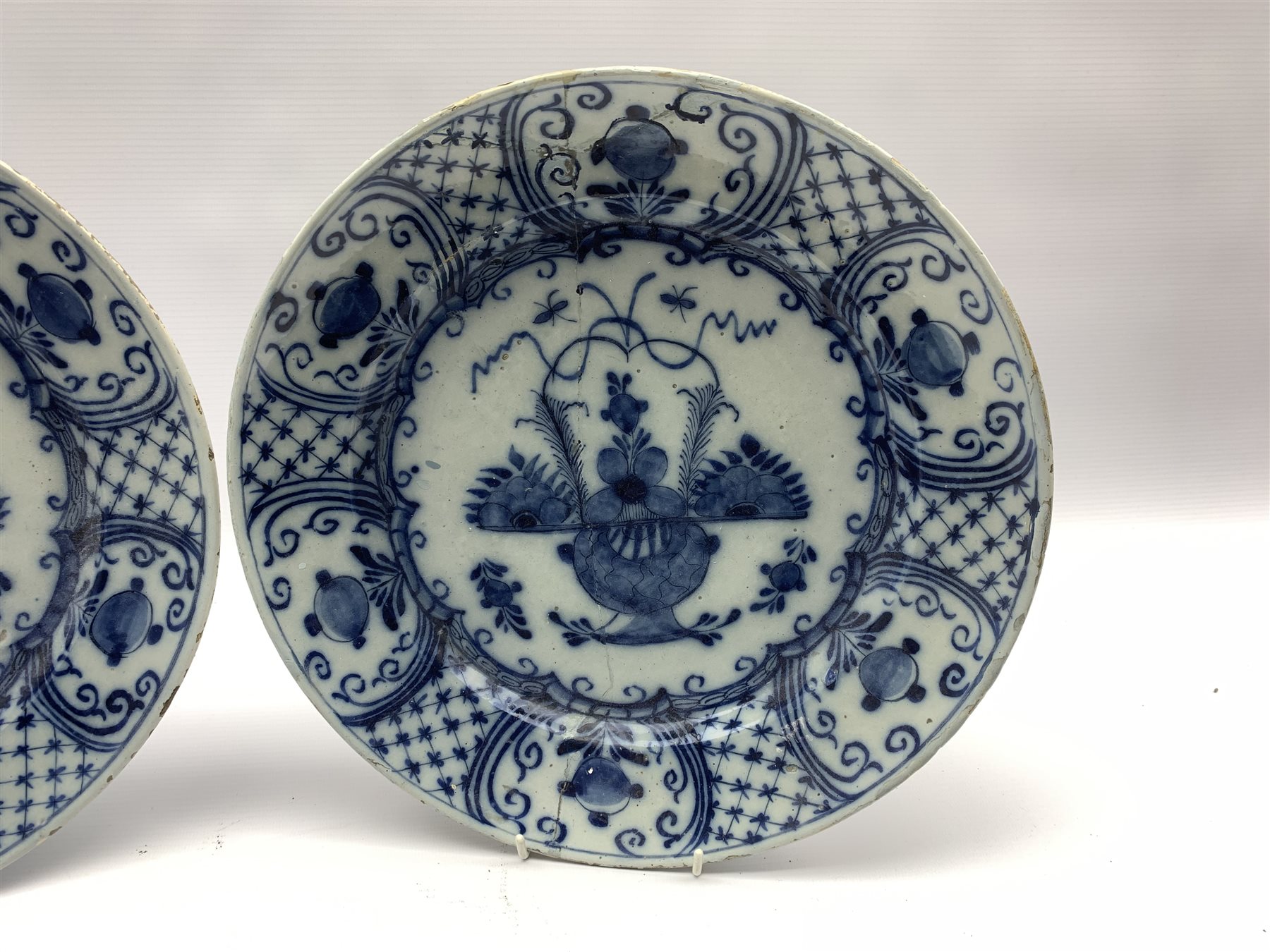 Pair of 18th century Delft blue and white chargers, centrally painted with a vase of flowers, the bo - Image 2 of 4
