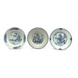 Three Chinese Export blue and white plates, two decorated with a fence garden and the other with chr