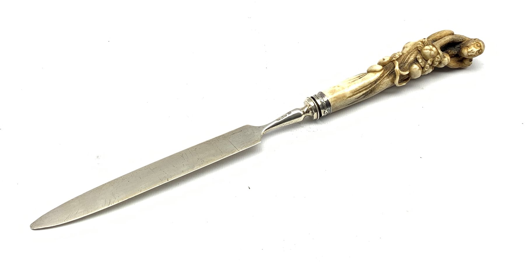 Edwardian silver and bone letter opener, the handle finely carved as a Monkey gathering fruit by Jam