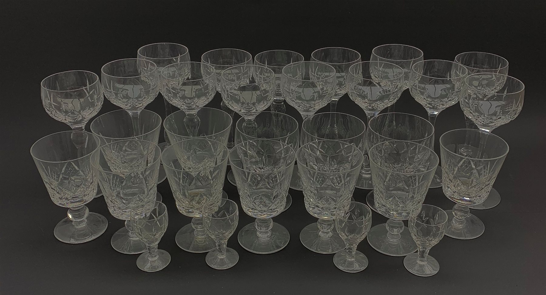 Part suite of Stuart crystal drinking glasses comprising fourteen hock glasses, twelve various shape