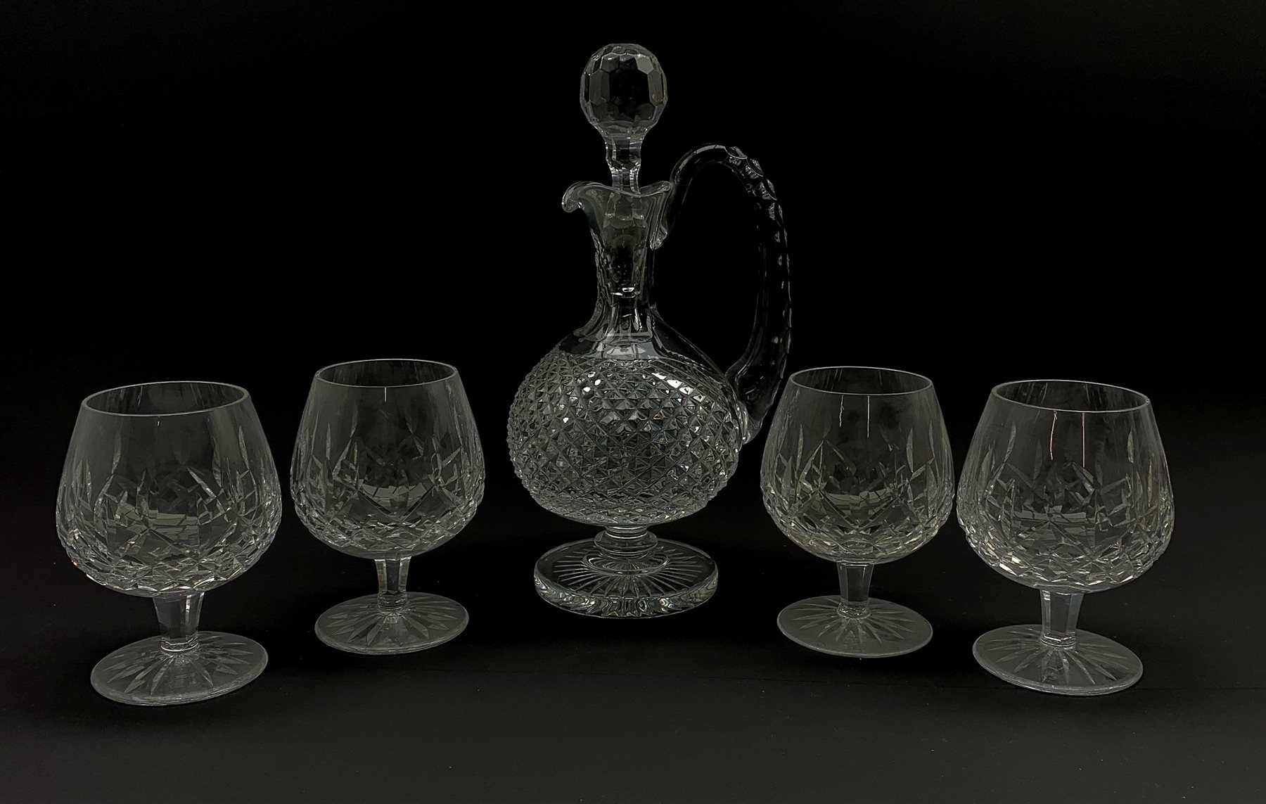 Waterford crystal claret decanter with certificate and four Waterford Crystal Lismore pattern brandy