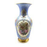 19th century French porcelain baluster vase painted with panels of flowers on a blue and gilt ground