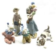 Three Lladro figures comprising The Balloon Seller, Gone Fishing and Playful Puppy and two Nao Clown
