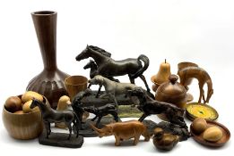 Collection of turned wooden items including a bottle shaped vase with fluted carved decoration, turn