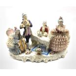 German porcelain musical figure group, comprising a seated gentleman playing a piano, a standing gen