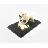 WWII British Propaganda ivory model of a Bulldog tearing up the German flag, mounted on ebony base,