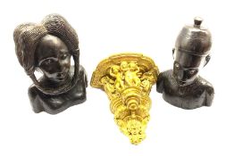 Pair of African carved ebony male and female heads H33cm and a painted plaster wall bracket W30cm