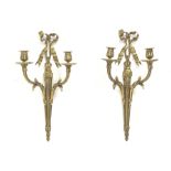 Pair late 20th Century gilt metal wall sconces, ruffled ribbon pediment on tapering husk stop fluted