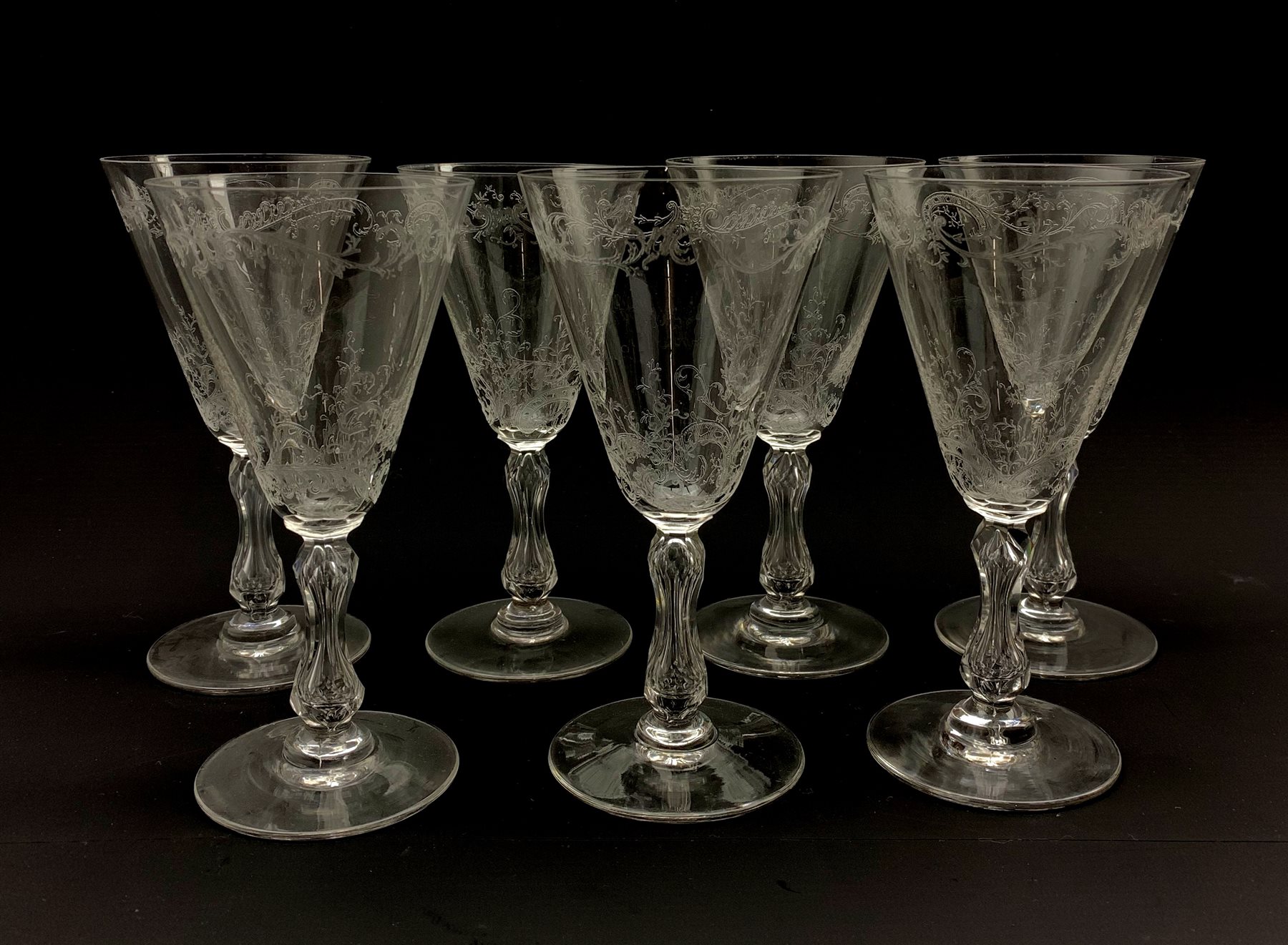 Set of seven early 20th century claret glasses decorated in the Baccarat style with foliate engraved