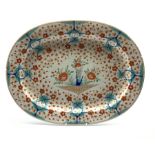 Early 19th century oval meat plate painted with Japanese flowers in orange and blue W52cm