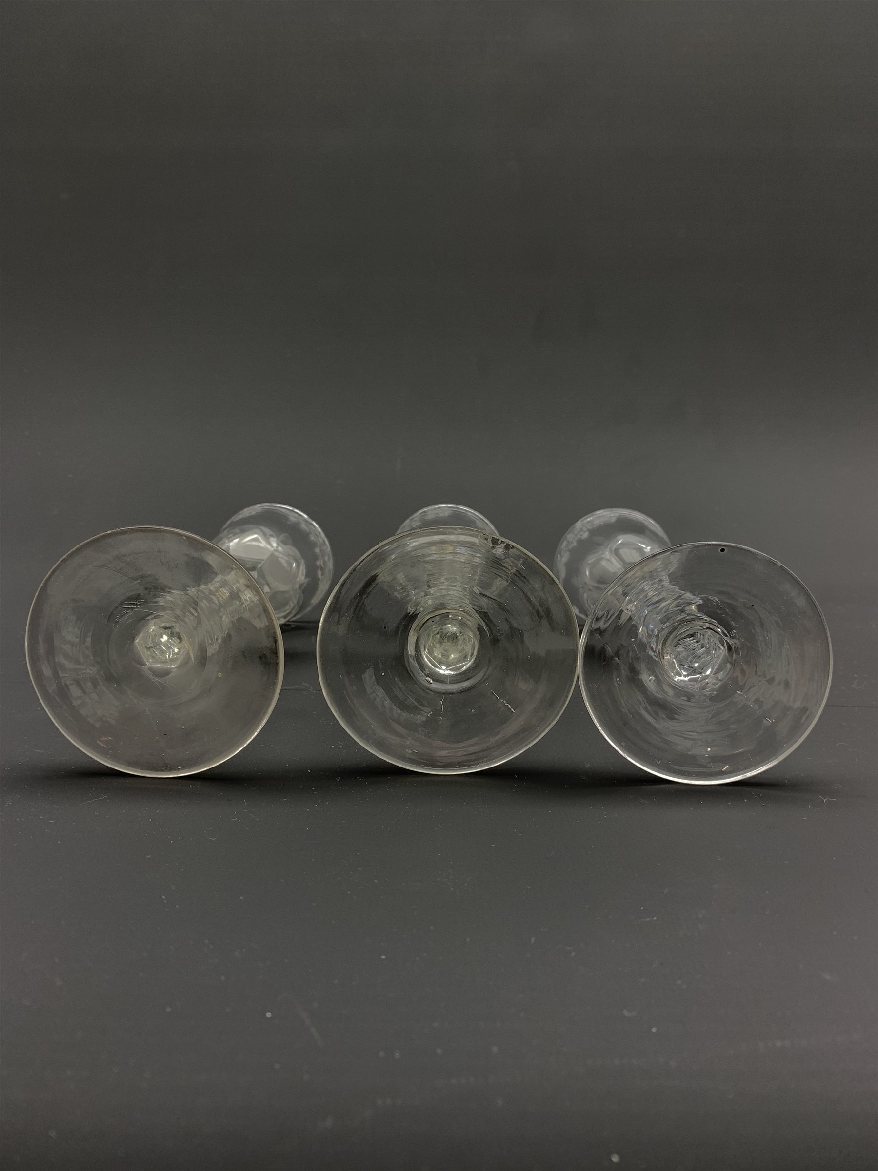 Set of three 18th century wine glasses, the ovoid bowls engraved with flower sprigs on faceted stems - Image 4 of 4