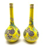 Pair of Japanese Meiji period bottle shaped vases decorated with Dragons amidst clouds and mon on ye