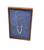 Set of Viking high status ladies personal jewellery mounted in a mahogany glazed display case, 61cm