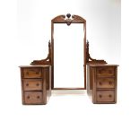 Victorian mahogany pedestal dressing table, the swing mirror with broken arch pediment, raised on tw