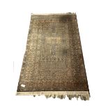 Tribal Hadklu design ground rug, with Mihrab motif enclosed by double guarded border, (125cm x 210cm