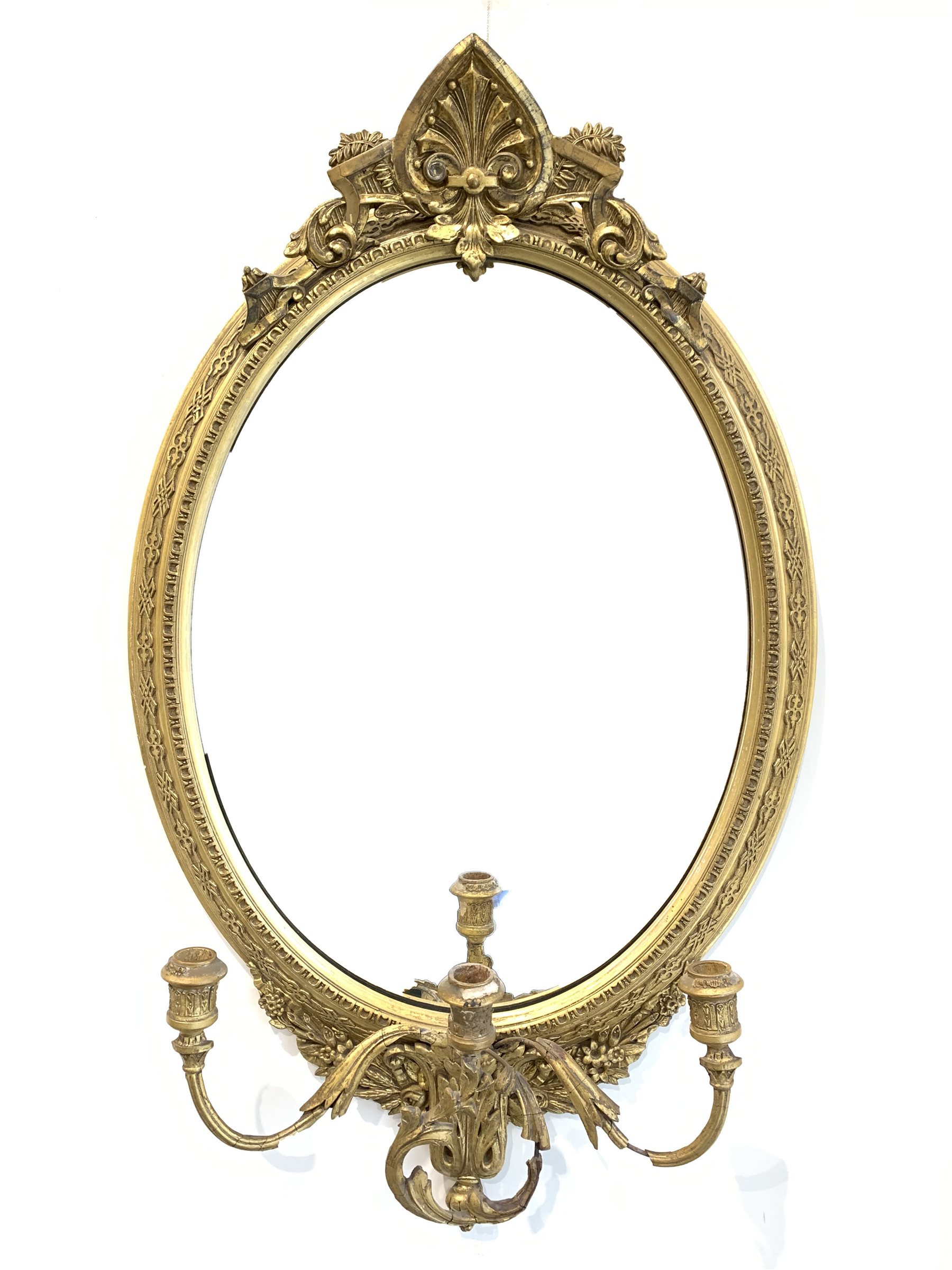 Late 19th century gilt wood and gesso framed wall mirror, anthemion pediment above oval mirror plate