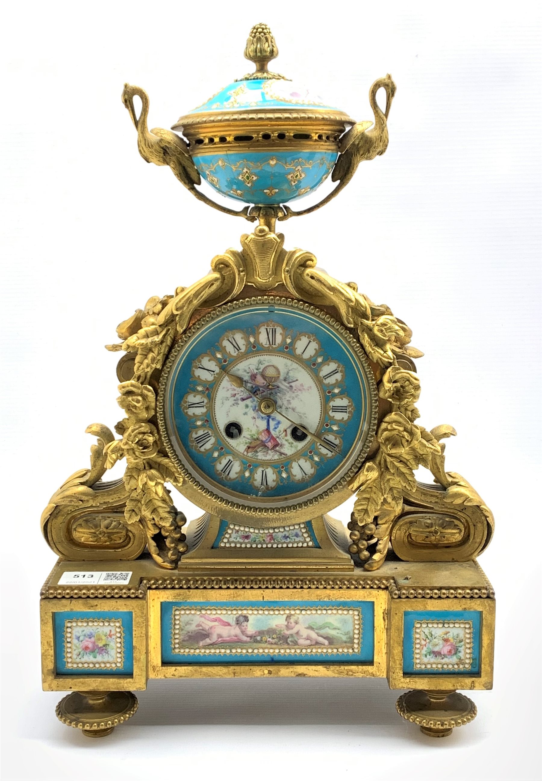 19th century French mantel clock, gilt metal with urn finial over case profusely decorated with a fl