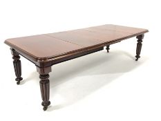 Victorian mahogany extending dining table with three leaves, raised on reeded supports and ceramic c