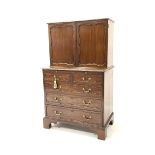 George II style cupboard on chest, the top section with two panel doors enclosing interior fitted wi