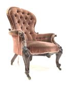 Victorian mahogany armchair, upholstered in deep buttoned velvet, with scroll and floral carved arm
