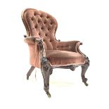 Victorian mahogany armchair, upholstered in deep buttoned velvet, with scroll and floral carved arm