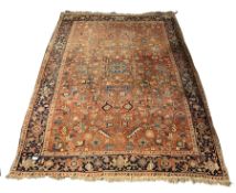 Persian design carpet, with geometric design on red field, guarded border, 254cm x 340cm