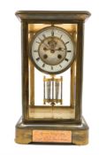 Late 19th century brass and four glass presentation clock, with white enamel dial and Roman numeral