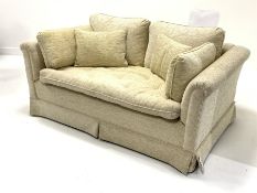 Two seat sofa upholstered in beige fabric, loose cushions, raised on castors, W147cm